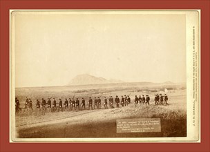 Company C, 3rd U.S. Infantry, caught on the fly, near Fort Meade. Bear Butte in the distance, John