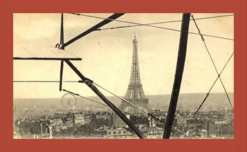 An aerial view of the Eiffel Tower in Paris, seen through the framework of a biplane, France,