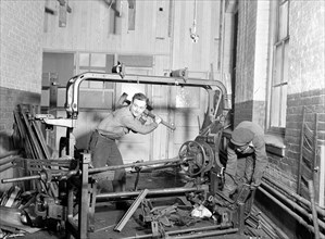 Paterson, New Jersey - Textiles. Junkies breaking up old looms, to be sold for scrap-iron and said