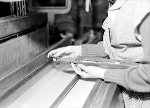Paterson, New Jersey - Textiles. Weaver threading shuttle, March 1937, Lewis Hine, 1874 - 1940, was