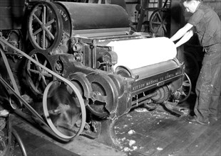 Millville, New Jersey - Textiles. Millville Manufacturing Co. [Man rolling fabric.], 1936, Lewis