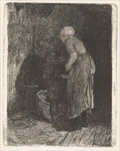 Woman looking in a crib, Bernardus Johannes Blommers, 1855 - 1914
