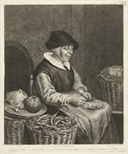 An old woman sitting in the kitchen on a chair and blanked beans in her apron, beside her are