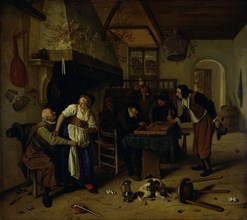 Interior of an inn with an old man amusing himself with the landlady and two men playing