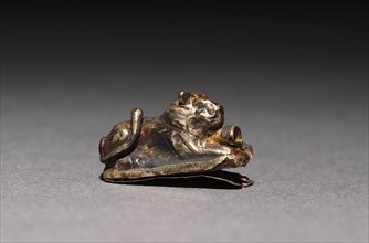 Recumbent Lion Bead, 1980-1801 BC. Egypt, Middle Kingdom, Dynasty 12. Electrum over a clay-bulked