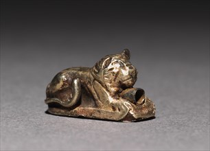 Recumbent Lion Bead, 1980-1801 BC. Egypt, Middle Kingdom, Dynasty 12. Electrum over a clay-bulked