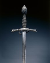 Rapier, c. 1600. Italy, early 17th Century. Steel, wire grip; hilt blued and chiseled with foliate