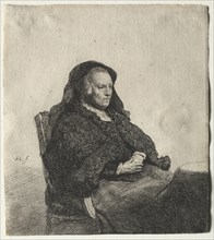 The Artist's Mother Seated at a Table, Looking Right: Three Quarter Length, c. 1631. Rembrandt van