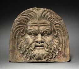 Antefix with Satyr Face, 370-330 BC. Italy, mid-4th Century BC. Terracotta; overall: 17.1 cm (6 3/4
