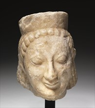 Archaic Head of a Sphinx, 500s BC. Greece, 6th Century BC. Marble; overall: 27 x 20.5 x 26.3 cm (10