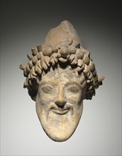 Head of Bearded Dionysus, 6th Century BC. Italy, provincial Greece, 6th Century BC. Terracotta;