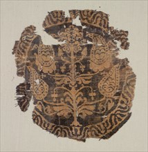 Roundel with curvilinear palmette tree, from a tunic, 600-850. Egypt or possibly Syria. Samite: