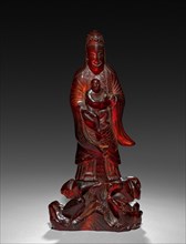 Guanyin, 18th Century. China, Qing dynasty (1644-1911). Amber; overall: 16.9 cm (6 5/8 in.).