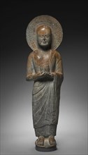 Standing Disciple Mahakasyapa Holding a Cylindrical Reliquary, c. 550. China, Hebei province,