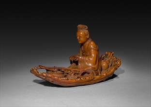 Taoist Immortal He Xiangu, 1700s. China, Qing dynasty (1644-1911). Boxwood with stained ivory base;
