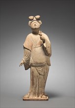 Woman Holding Plum Blossoms, mid 700s. North China, Tang dynasty (618-907). Earthenware covered in