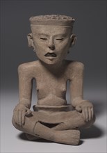 Seated Figure Wearing a Skin, 600-1000. Mexico, Gulf Coast, 7th-11th Century. Earthenware, slip;