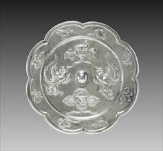 Lobed Mirror with Paired Phoenixes, a Nestling Bird, and a Lotus Blossom, 700s. China, Tang dynasty