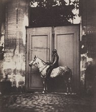 Black Horseman in Front of a Doorway, c. 1855. Unidentified Photographer. Salt print from wet