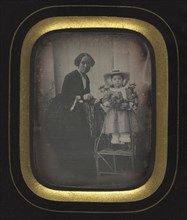Child Standing on a Chair Holding Flowers, with Mother, c. 1855. Unidentified Photographer.