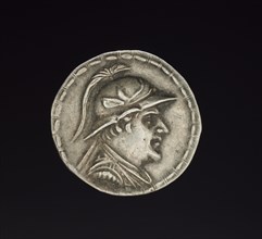 Coin of Eukratides I, 170-145 BC. Afghanistan, Bactria, c. 2nd century BC. Silver; diameter: 3.3 x