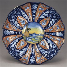 Molded Dish with an Allegory of Love; Faenza, Emilia-Romagna, Italy; about 1535; Tin-glazed earthenware; 7.3 x 27.9 cm