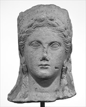 Head from a Statue of a Woman; Cyprus; late 4th century B.C; Limestone; 36.2 × 19.1 × 21 cm, 14 1,4 × 7 1,2 × 8 1,4 in