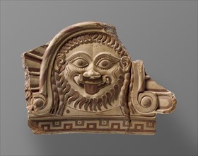 Fragmentary Roof Ornament with Medusa; Campania, Italy; about 500 B.C; Terracotta with polychromy; 26.2 × 39.1 × 6 cm