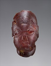 Pendant: Female Head; Italy; 500 - 480 B.C; Amber; 42 × 24 × 29 mm, 1 5,8 × 15,16 × 1 1,8 in