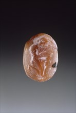 Engraved Scarab; Sphinx and Youth Group II; Greece; late 6th century B.C; Carnelian; 1 x 1.6 x 1.1 cm, 3,8 x 5,8 x 7,16 in