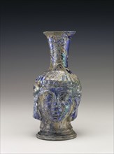 Flask in the Shape of a Head; Roman Empire; 4th - 5th century; Glass; 17.2 × 8 cm, 6 3,4 × 3 1,8 in