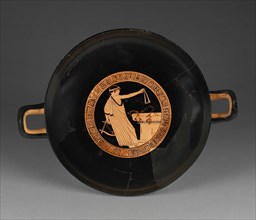 Wine Cup with a Boy Dedicating the Mouth Strap of a Wind Instrument; Attributed to Brygos Painter, Greek, Attic