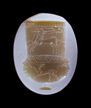 Gem: Mixing Vessel Decorated with a Chariot and a Panther; Italy; 1st century B.C; Banded agate, blue and brown; 1.6 × 1.3 × 0.3