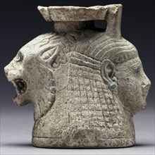 Oil Container with the Heads of a Lion and a Woman; Rhodes, Greece; mid-6th century B.C; Faience; 5.6 × 6 × 4 cm