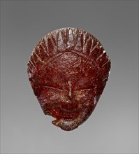 Pendant: Head of a Female Divinity or Sphinx; Italy; 550 - 525 B.C; Amber; 32 × 26 × 12 mm, 1 1,4 × 1 × 1,2 in