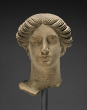 Head of a Woman; Tarentum, Taras, South Italy; about 350 B.C; Terracotta with clay slip and polychromy, red, 23.5 × 17.2 cm