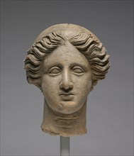 Head of a Woman; Tarentum, Taras, South Italy; about 350 B.C; Terracotta; 17.8 × 14.1 cm, 7 × 5 9,16 in