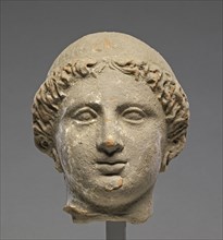 Head of a Woman; Tarentum, Taras, South Italy; 350 - 300 B.C; Terracotta with white slip; 14.4 × 11.5 cm, 5 11,16 × 4 1,2 in