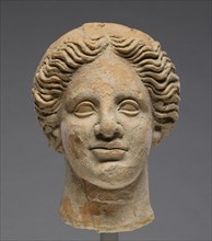 Head of a Woman; Orpheus Master; Tarentum, Taras, South Italy; 350 - 300 B.C; Terracotta with clay slip; 16.5 × 12.6 cm