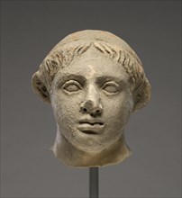 Head of a Youth; Tarentum, Taras, South Italy; 400 - 350 B.C; Terracotta with clay slip; 13.4 × 12.2 cm, 5 1,4 × 4 13,16 in