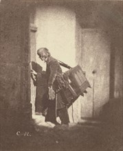Organ Grinder at 21, quai Bourbon; Charles Nègre, French, 1820 - 1880, Paris, France; before March or May 1853; Salted paper