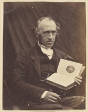 Portrait of Seated Man with a Book; British; 1870 - 1875; Albumen silver print