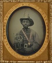 Fireman in Uniform Holding a Brass Instrument; American; 1855 - 1856; Daguerreotype, hand-colored; 6 x 4.9 cm