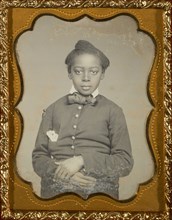 Portrait of a Seated Black Child with Hands Crossed; American; about 1857 - 1858; Daguerreotype, hand-colored; 5.2 x 4 cm