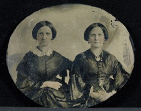 Portrait of Two Seated Women; American; about 1860; Ambrotype, Ruby glass, hand-colored; Glass: 6 x 7.3 cm 2 3,8 x 2 7,8 in