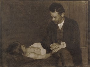 Man Seated Beside Supine Child; Heinrich Kühn, Austrian, born Germany, 1866 - 1944, 1900 - 1910; Gum bichromate print