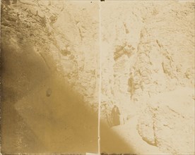Man standing at base of cliff wall; about 1860 - 1880; Tinted Albumen silver print