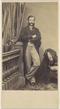 man with moustache & muttonchops, standing with arms crossed; about 1865; Albumen silver print