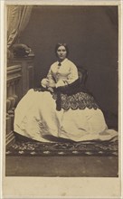 woman in a white dress with dark shawl, seated; about 1865; Albumen silver print