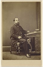 bearded man seated at writing desk, in 3,4 profile; London Stereoscopic and Photographic Company; about 1865; Albumen silver